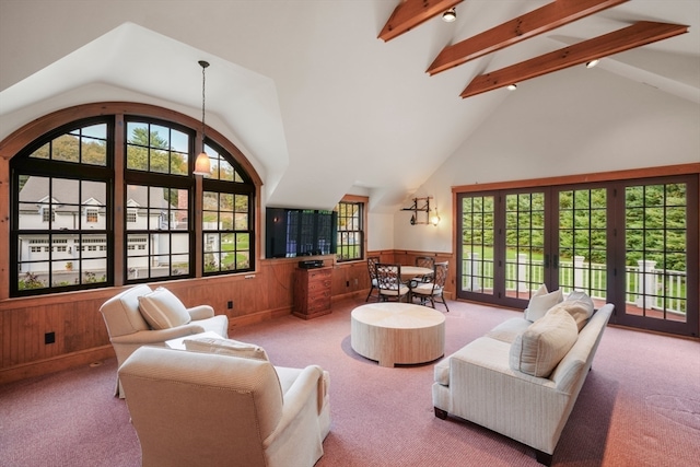 living room featuring french doors, lofted ceiling with beams, wooden walls, and carpet