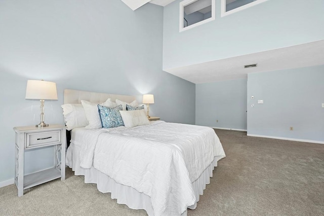 carpeted bedroom with visible vents and baseboards