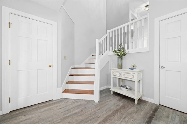 stairs featuring baseboards and wood finished floors
