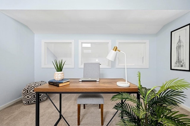 office space featuring baseboards and light carpet