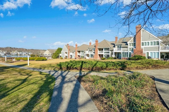 view of home's community featuring a residential view and a yard