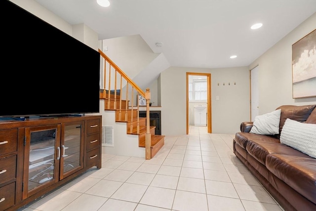 living area featuring light tile patterned floors, stairway, visible vents, and recessed lighting