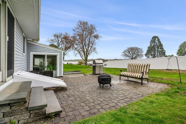view of patio / terrace with area for grilling, a fire pit, and fence