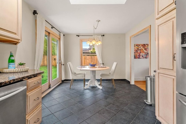 dining space featuring a chandelier and baseboards