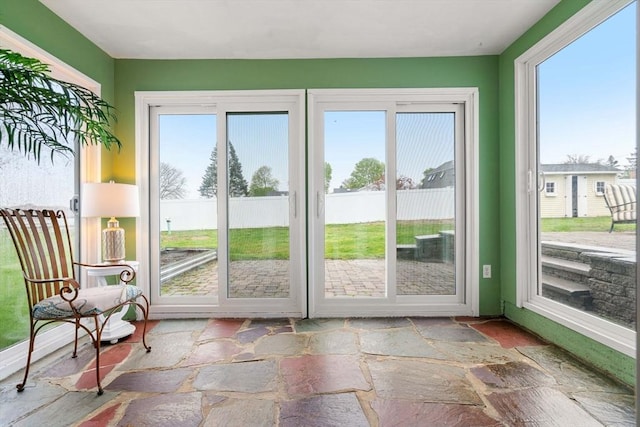 sunroom featuring stone tile flooring