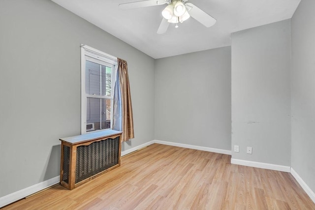 unfurnished room featuring ceiling fan, baseboards, and wood finished floors