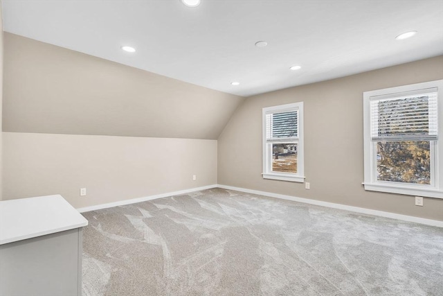 additional living space with lofted ceiling, carpet, a wealth of natural light, and baseboards