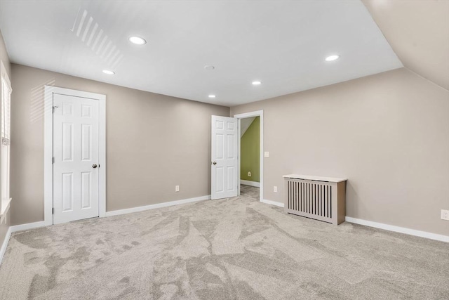 interior space featuring recessed lighting, vaulted ceiling, and baseboards