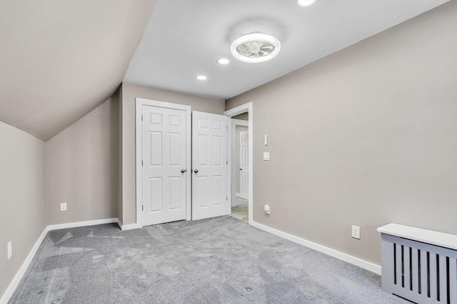 unfurnished bedroom featuring lofted ceiling, recessed lighting, carpet flooring, and baseboards