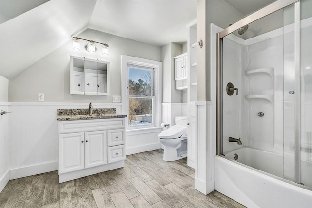 bathroom with vanity, wainscoting, wood finished floors, and toilet