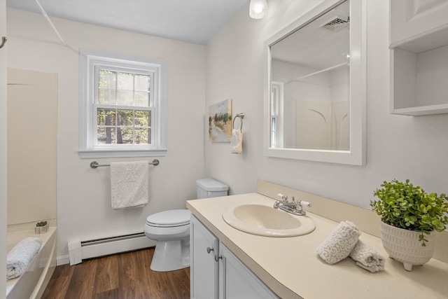 full bathroom with vanity, toilet, wood finished floors, a baseboard radiator, and visible vents
