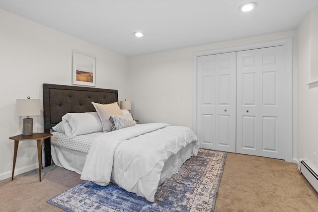 carpeted bedroom with a closet, baseboards, a baseboard heating unit, and recessed lighting