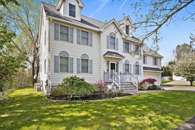 view of front facade featuring a garage, central AC, a front lawn, a shingled roof, and asphalt driveway