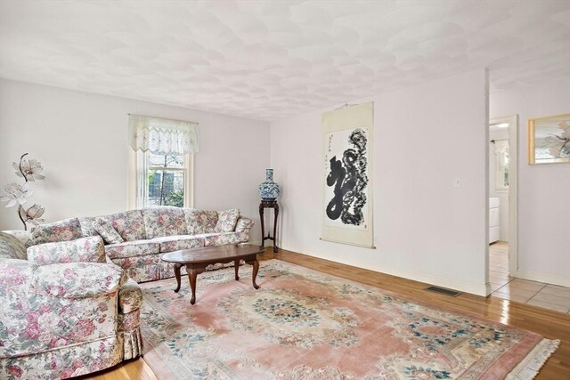 living area featuring wood finished floors and baseboards