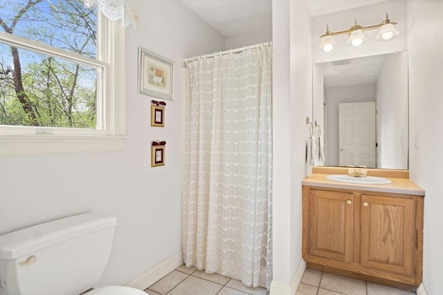full bathroom featuring tile patterned floors, baseboards, vanity, and toilet