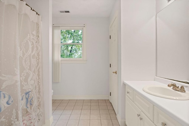 bathroom featuring tile patterned floors, vanity, toilet, baseboards, and a shower with shower curtain