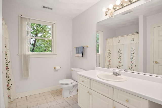 bathroom with baseboards, tile patterned flooring, toilet, and vanity