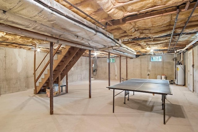 below grade area featuring gas water heater and stairs