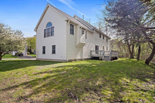 back of house featuring a deck and a yard