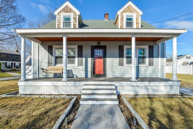 view of front of home featuring covered porch and a front yard