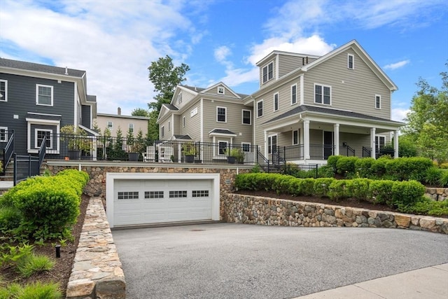 26 Dalby St, Newton, MA 02458 - view of front facade featuring driveway, an attached garage, stone siding, and stairway