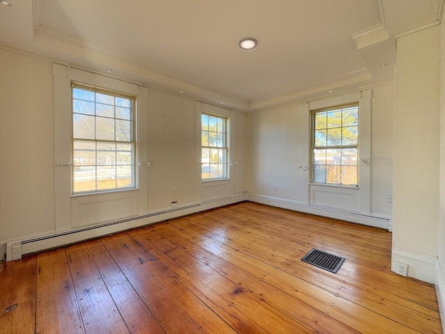 spare room with ornamental molding, light hardwood / wood-style floors, and baseboard heating