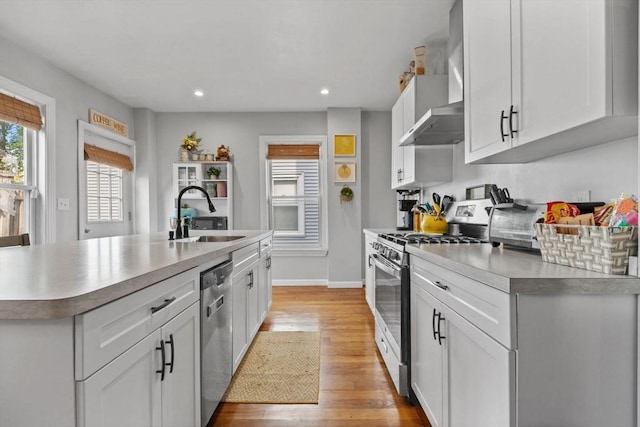 10 Atkins Ave, Lynn, MA 01904 - kitchen with appliances with stainless steel finishes, a sink, light wood-style floors, white cabinetry, and recessed lighting