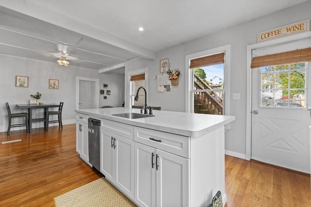 10 Atkins Ave, Lynn, MA 01904 - kitchen featuring a sink, stainless steel dishwasher, light countertops, light wood-type flooring, and white cabinets