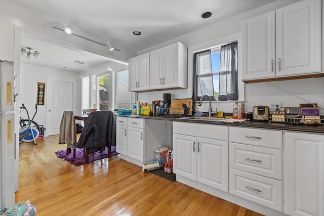 10 Atkins Ave, Lynn, MA 01904 - kitchen with light wood finished floors, a sink, dark countertops, and healthy amount of natural light