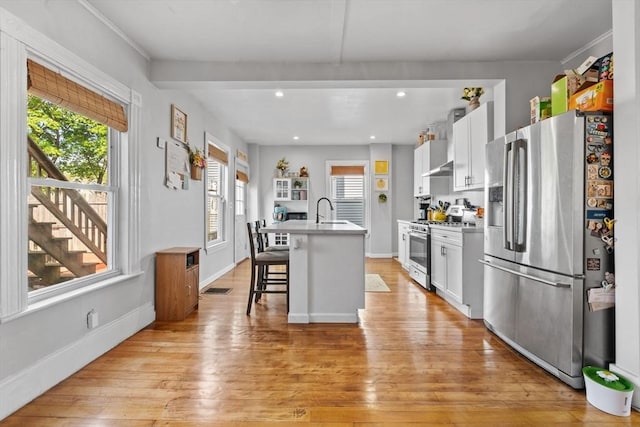 10 Atkins Ave, Lynn, MA 01904 - kitchen featuring appliances with stainless steel finishes, a kitchen breakfast bar, a sink, a center island with sink, and healthy amount of natural light