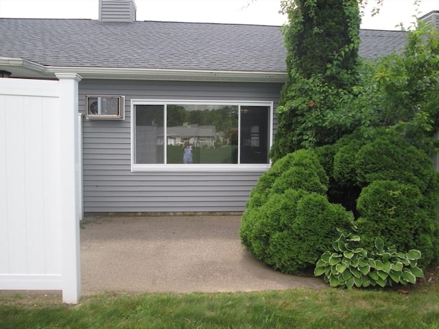 26 Horseshoe Dr Unit 26, Chicopee, MA 01022 - view of property exterior with roof with shingles, a chimney, and a patio