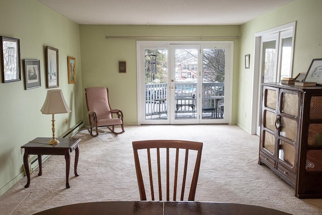 sitting room featuring light carpet, french doors, and baseboards