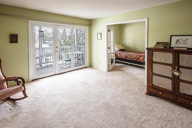 bedroom with access to outside, light colored carpet, a textured ceiling, and french doors