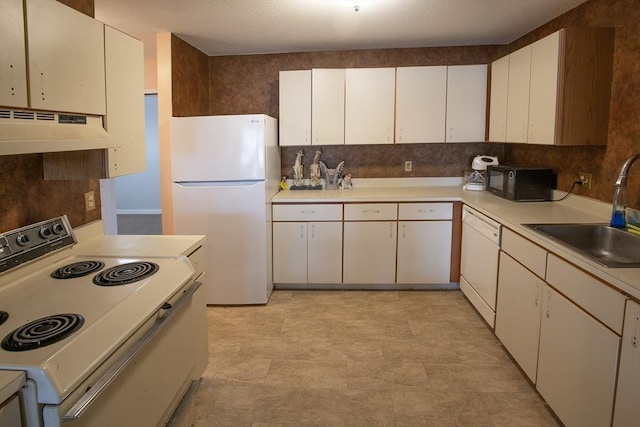 kitchen with under cabinet range hood, white appliances, a sink, white cabinets, and light countertops