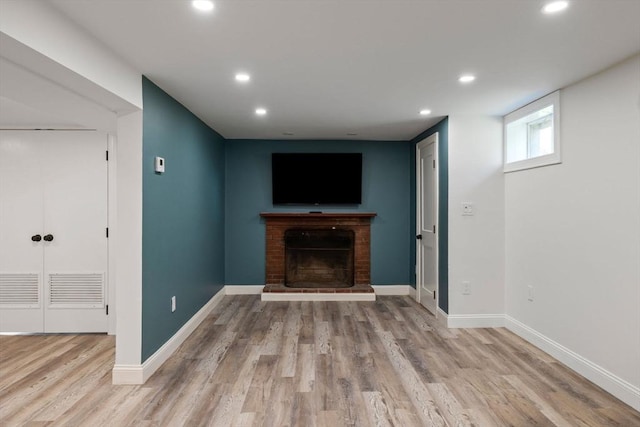 8 Whispering Hill Rd, Woburn, MA 01801 - unfurnished living room featuring wood finished floors, a brick fireplace, and recessed lighting