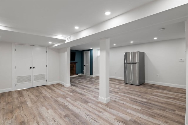 8 Whispering Hill Rd, Woburn, MA 01801 - finished basement with freestanding refrigerator, visible vents, recessed lighting, light wood finished floors, and baseboards