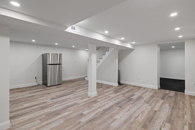 8 Whispering Hill Rd, Woburn, MA 01801 - finished below grade area featuring freestanding refrigerator, light wood finished floors, visible vents, and recessed lighting