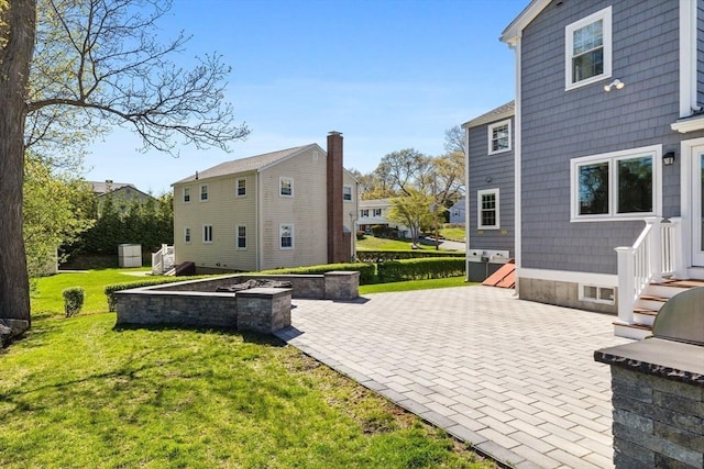 8 Whispering Hill Rd, Woburn, MA 01801 - rear view of house featuring entry steps, a patio area, a residential view, and a lawn