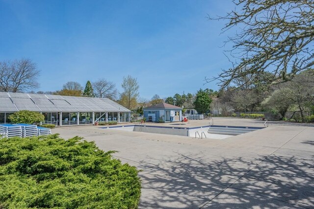 pool with fence and a patio