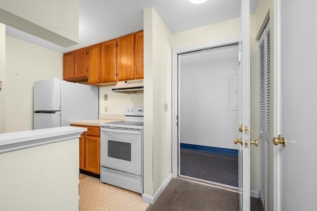 kitchen featuring brown cabinetry, white appliances, baseboards, light countertops, and under cabinet range hood
