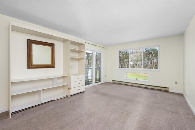 unfurnished living room featuring baseboards, a baseboard radiator, carpet flooring, and a healthy amount of sunlight
