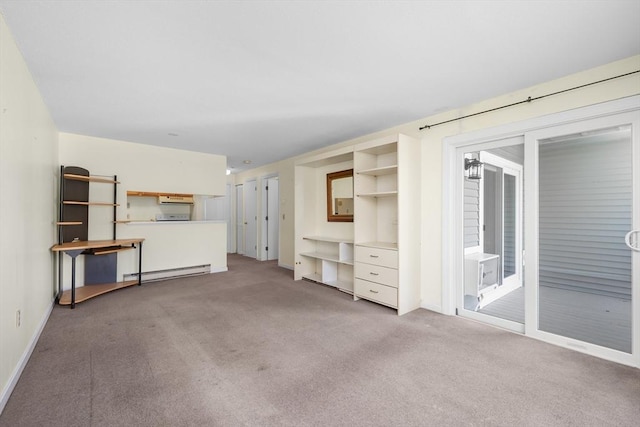unfurnished living room with baseboards, carpet flooring, and a baseboard heating unit