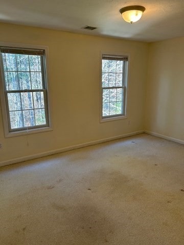 unfurnished room with light colored carpet