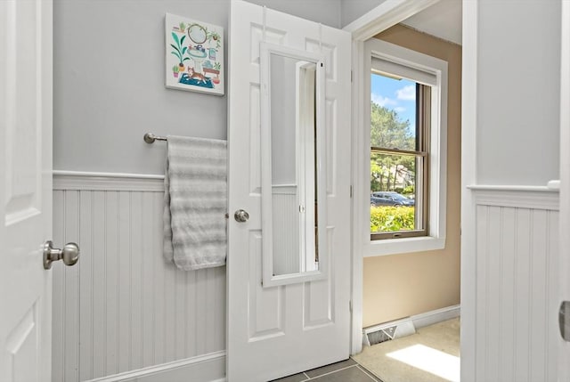 entryway with tile patterned flooring and plenty of natural light