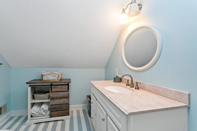 bathroom featuring vanity and lofted ceiling