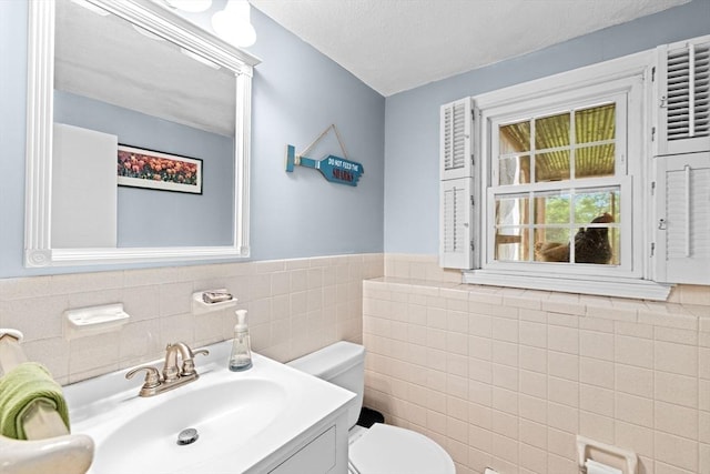 382 Tilden Rd, Scituate, MA 02066 - bathroom featuring tile walls, vanity, and a wainscoted wall