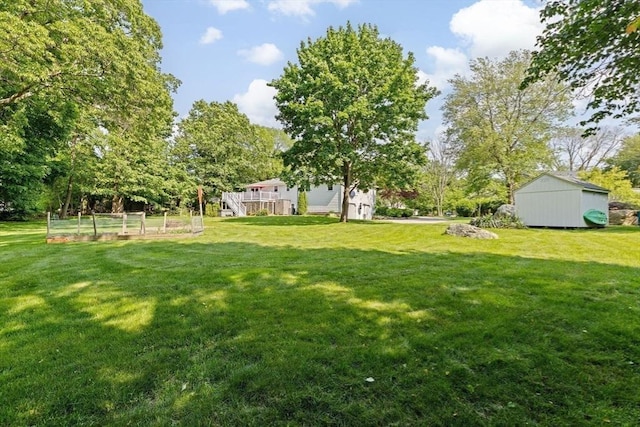 382 Tilden Rd, Scituate, MA 02066 - view of grassy yard with a garden, view of scattered trees, and an outdoor structure