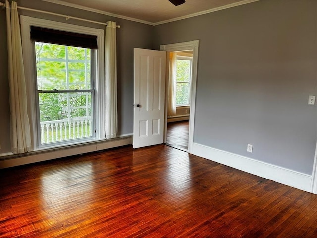 unfurnished room featuring crown molding, baseboards, ceiling fan, hardwood / wood-style flooring, and baseboard heating
