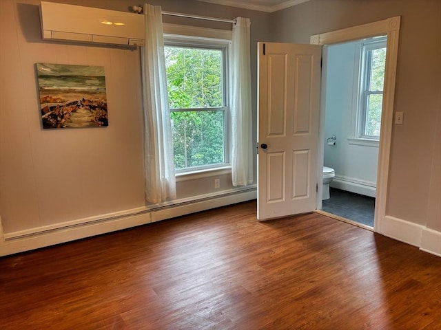 spare room with baseboard heating, ornamental molding, a wall mounted air conditioner, and healthy amount of natural light