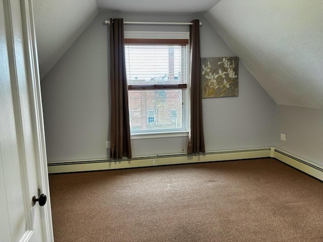 additional living space featuring vaulted ceiling, carpet flooring, a baseboard radiator, and a textured ceiling